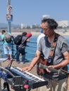 Vertical shot of a street musician performing at the Santa Monica pier on a sunny day Royalty Free Stock Photo