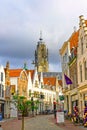 Vertical shot of a street with a view of a tower in the background in Middelburg, the Netherlands.