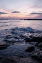 Vertical shot of a stunning sea under a pink sky