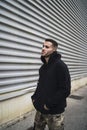 Vertical shot of a stylish attractive young man wearing a black hoodie Royalty Free Stock Photo