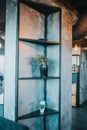 Vertical shot of a stylish metal shelf with flower pots in a modern interior