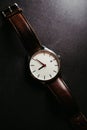 Vertical shot of a stylish wrist watch on dark background Royalty Free Stock Photo