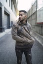 Vertical shot of a stylish young man wearing a hoodie and jeans Royalty Free Stock Photo