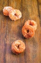 Vertical shot of sugary donuts on a wooden surface
