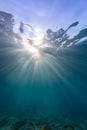 Vertical shot of sun rays sliding through the ocean reflecting on both sides in Samos Royalty Free Stock Photo