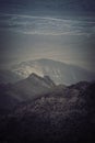 Vertical shot of the sun rising over a mountainous scenery at the canyon Royalty Free Stock Photo