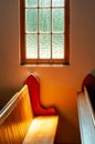 Vertical shot of the sunlit from the window over the pews sunlit in All Saints Church in New Zealand Royalty Free Stock Photo