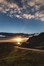 Vertical shot of a sunrise over a road in the middle of mountains in Lofoten, Norway Royalty Free Stock Photo