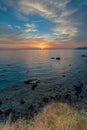 Vertical shot of the sunset over the beautiful calm ocean captured in Lesbos, Greece Royalty Free Stock Photo