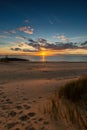 Vertical shot of the sunset reflecting in the ocean in Vlissingen, Zeeland, Netherlands