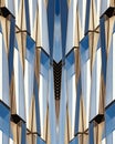 Vertical shot of a symmetrical blue glass and concrete building