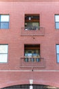 Vertical shot of a tall brick building with balcones