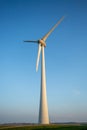 Vertical shot of tall wind-turbines along the Westermeerdijk in the Netherlands