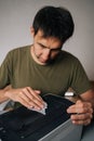 Vertical shot of technician cleaning printer with cloth, performing routine maintenance on essential office equipment Royalty Free Stock Photo