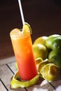Vertical shot of Tequila Sunrise cocktail in tall glass with straw