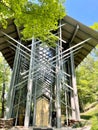 Vertical shot of the Thorncrown Chapel in Arkansas with trees in the background