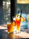 Vertical shot of three glasses of fresh cold juices on a table