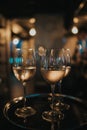 Vertical shot of three glasses of wine on a tray, in a restaurant Royalty Free Stock Photo