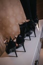 Vertical shot of three pairs of black high heel shoes on the table in the room Royalty Free Stock Photo