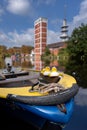 Vertical shot of three rubber ducks on a small boat in a harbor Royalty Free Stock Photo