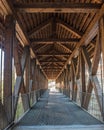 Vertical shot of a timber frame-covered bridge. Royalty Free Stock Photo