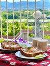 Vertical shot of toasts with eggs and iced coffee for breakfast in a balcony