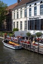 Vertical shot of a tour boat waiting for tourists to be seated in Brugge city, Belgium