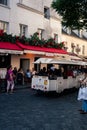 Vertical shot of a tourism trolley with people driving around in Montmartre, Paris, France Royalty Free Stock Photo