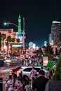 Vertical shot of tourists walking down the busy street in Las Vegas at night