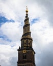 Vertical shot of the tower of Church of Savoir over a background of a cloudy sky