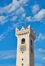 Vertical shot of the tower in Piazza Duomo, Trento with a blue cloudy sky in the background, Italy Royalty Free Stock Photo