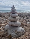 Vertical shot of a tower of rocks at the shore