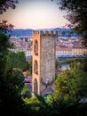 Vertical shot of The Tower of San Niccolo surrounded by buildings and trees in Florence, Italy