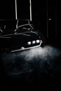 Vertical shot of Toyota Supra Mk5 headlights in the dark and fog