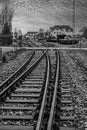 Vertical shot of tracks of a disused railway line in grayscale