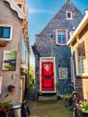 Vertical shot of traditional stone-made houses with outdoor flower decorations in the Netherlands