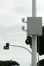 Vertical shot of a traffic camera on blurred background of a stoplight