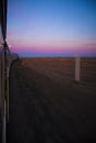 Vertical shot of train ride through desert with motion blur during sunset Royalty Free Stock Photo