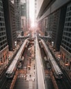 Vertical shot of a train symmetrically mirrored in the glass office building in Chicago, Illinois Royalty Free Stock Photo