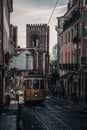 Vertical shot of trams of Lisbon riding down the beautiful old streets