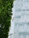 Vertical shot of tree with the sign of Dior shop in Paris on Champs Elysees street, France Royalty Free Stock Photo