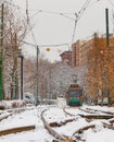 Vertical shot of a trolley making its way on the snowy trails in Boston
