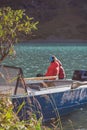 Vertical shot of two campers sitting on the boat in the river and enjoying the view Royalty Free Stock Photo