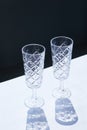 Vertical shot of two crystal champagne glasses
