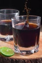 Vertical shot of two glasses of alcoholic drinks with soda and lime on the table Royalty Free Stock Photo