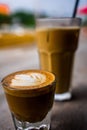 Vertical shot of two glasses of cortado and iced latte Royalty Free Stock Photo