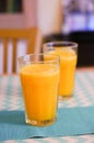 Vertical shot of two glasses of fresh orange juice