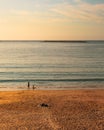 Vertical shot of two kids relaxing on the beach on a sunny day Royalty Free Stock Photo