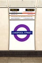 Vertical shot of an underground subway station featuring a bright, train sign in the United Kingdom