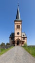 Vertical shot of Vagan\'s wooden church with pointed spire against Nordland\'s blue sky Royalty Free Stock Photo